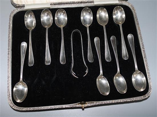 Ten George V silver coffee spoons and a pair of tongs, in a case for twelve,